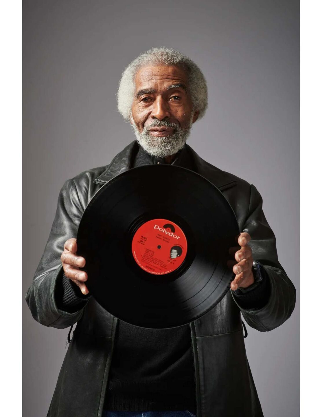Fred Thomas holding a vinyl record of James Brown's "Hot Pants"