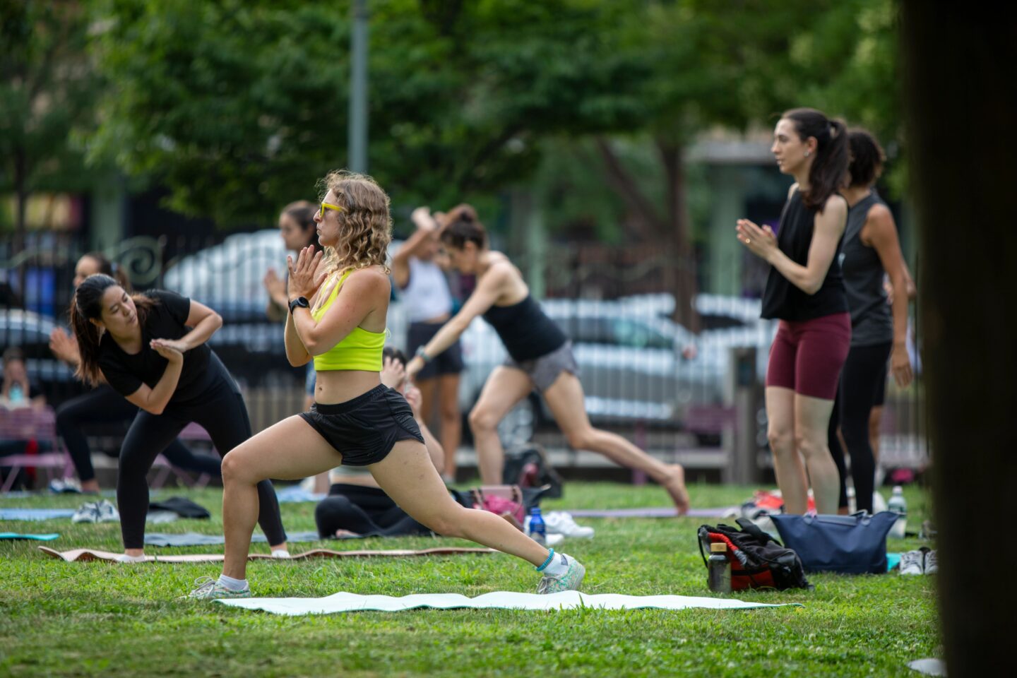 People hold a yoga pose during a Healthy on the Hudson yoga class at 14th Street Park