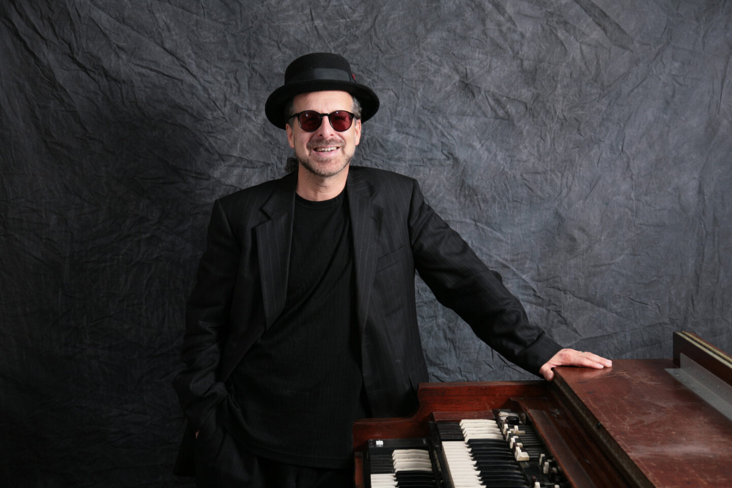 Radam Schwartz standing alongside a Hammond organ