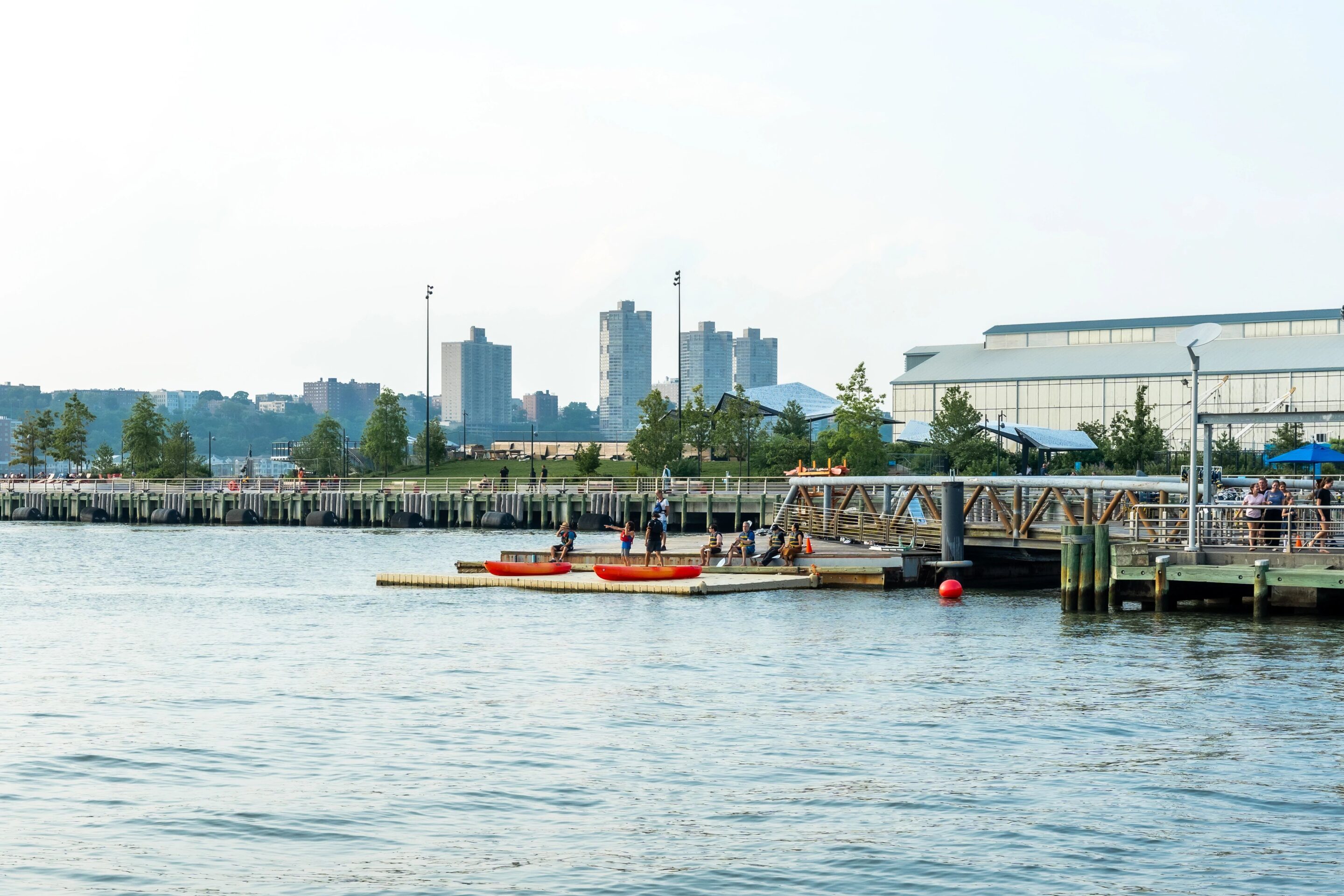 People in kayaks setting off from the Pier 96 Boathouse