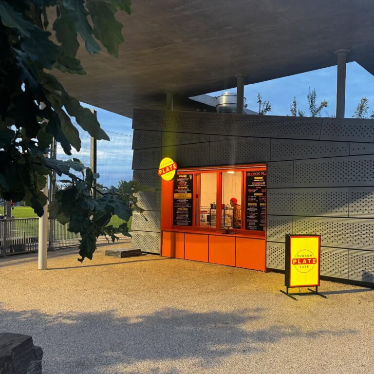 The order and pick-up window of Hudson Plate Cafe at sunset, located at Gansevoort Peninsula