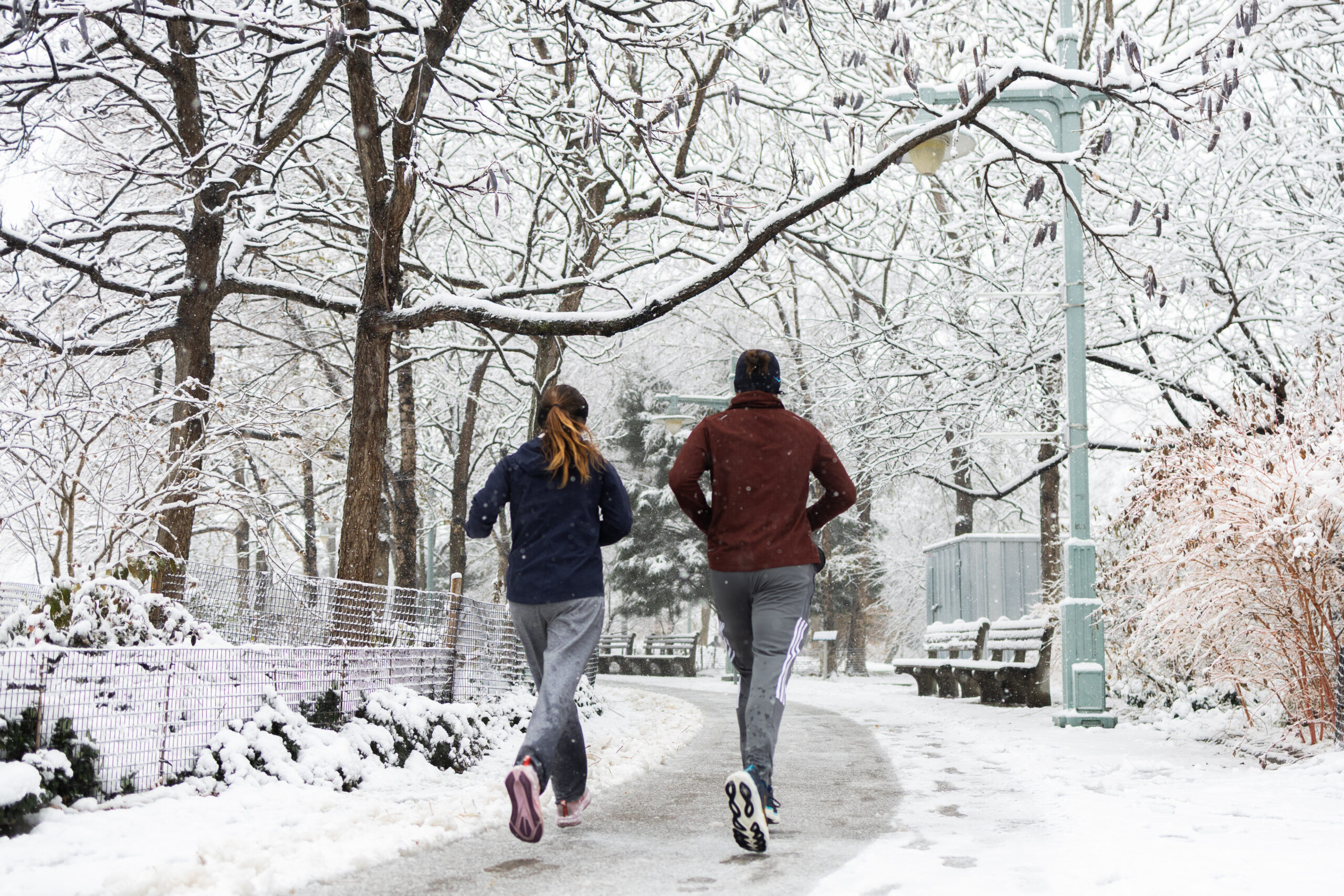 People running on snowy day in Hudson River Park