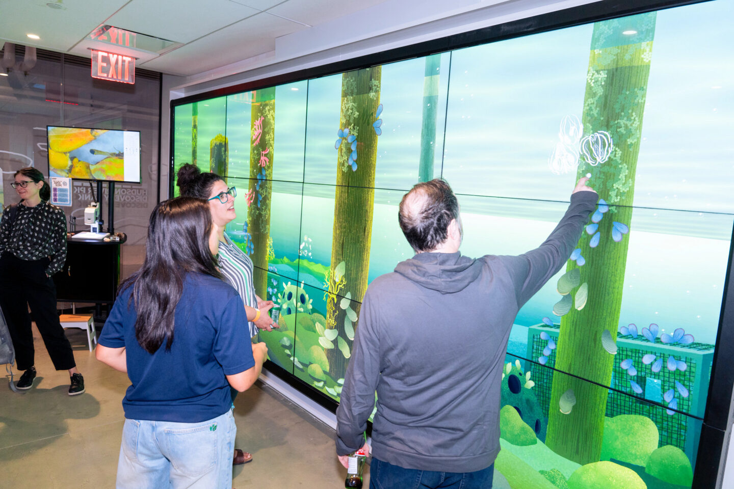 Group of people engaging with touch screen
