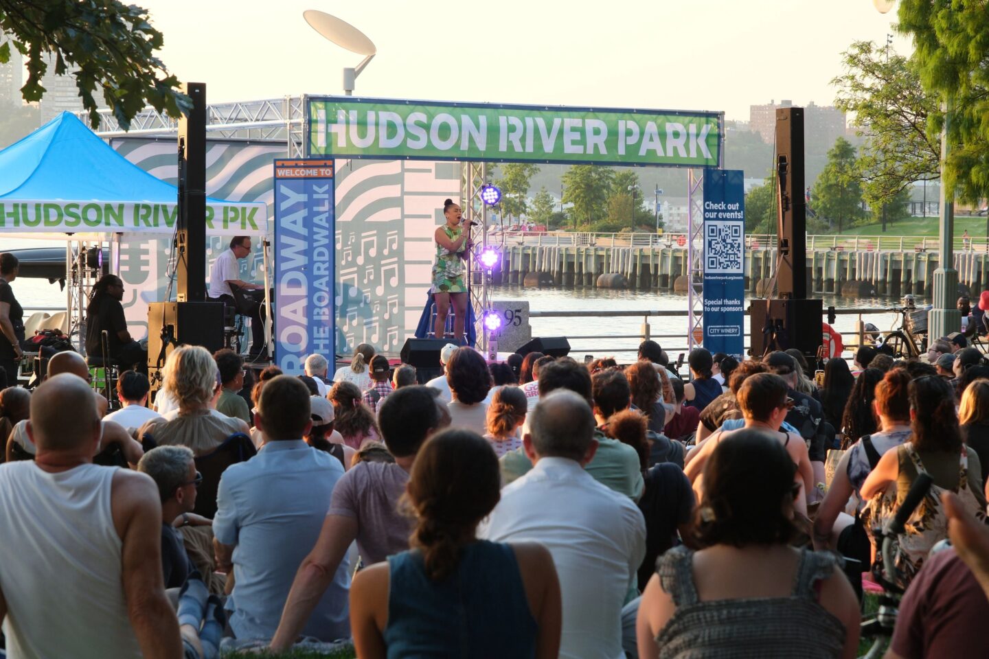 A large crowd watches as Jasmine Amy Rogers performs during a Broadway by the Boardwalk performance at Clinton Cove