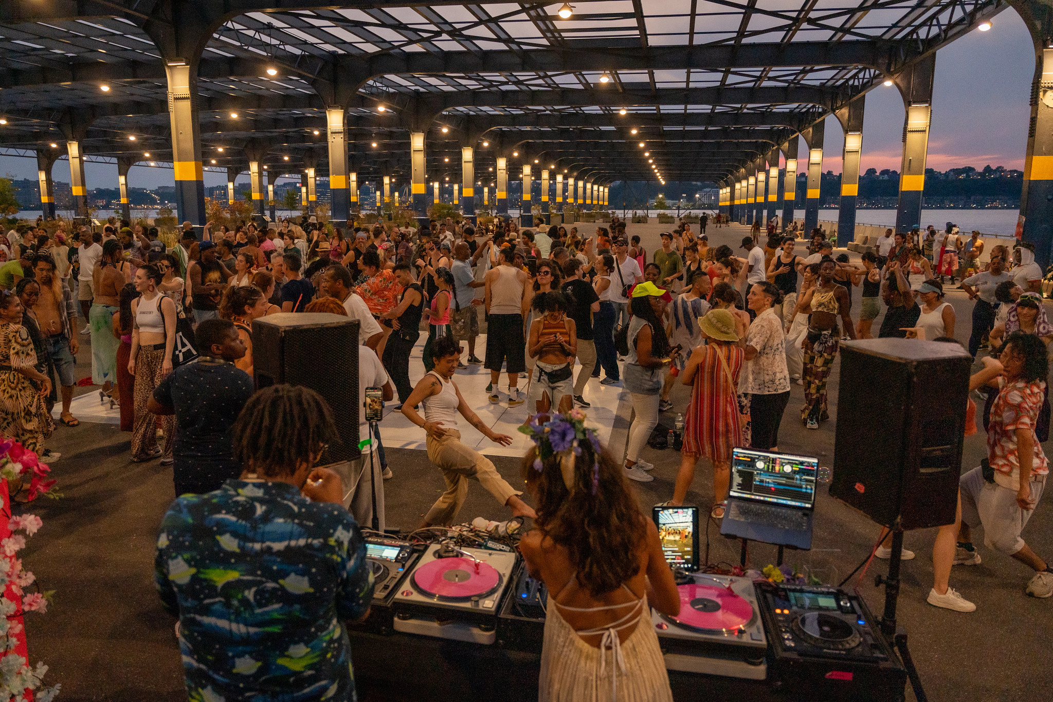 A DJ dances along with the audience at a Dance is Life event on Pier 76