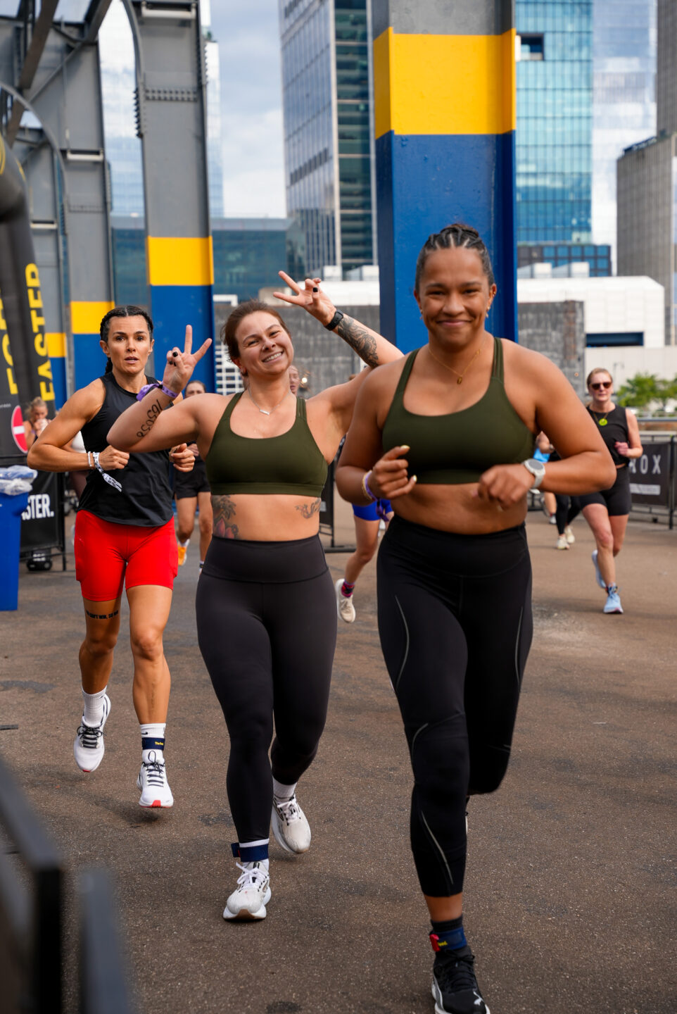 Three HYROX participants run in a line on Pier 76