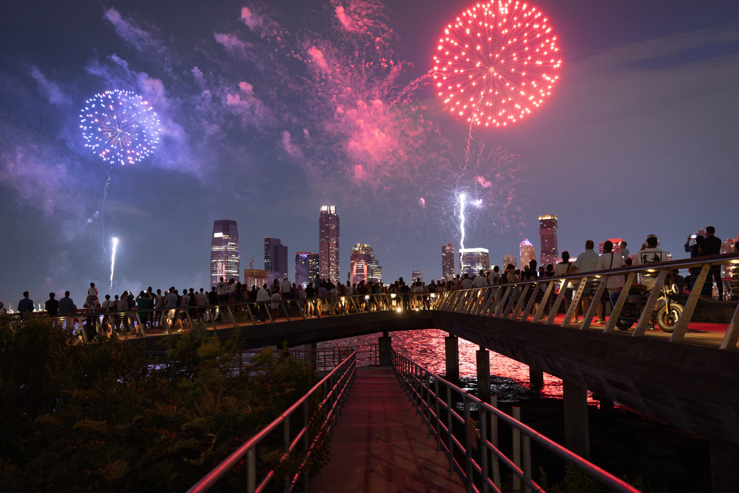 Crowds gather at edge of Pier 26 to watch fireworks display over Hudson River