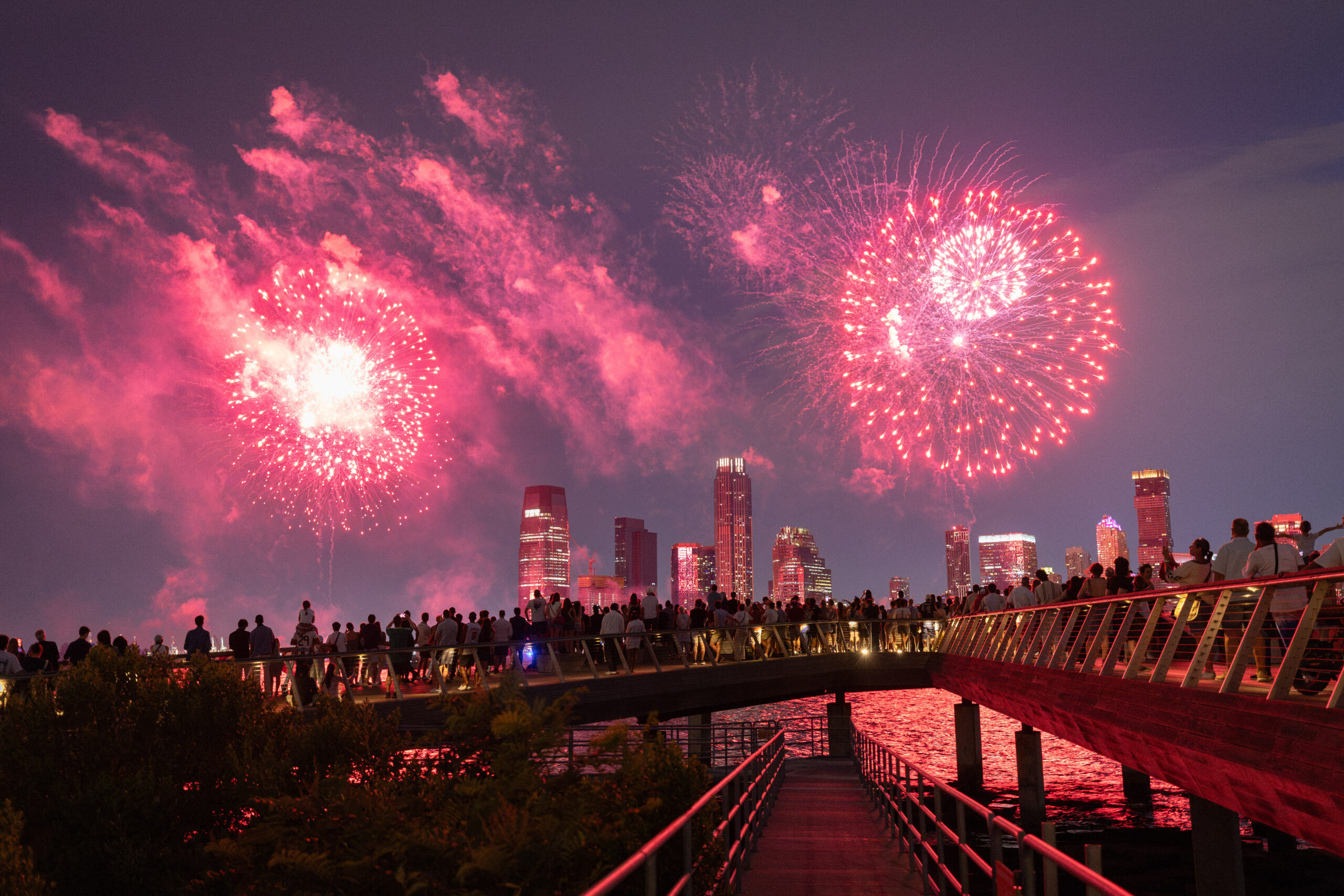 Crowds gather at edge of Pier 26 to watch fireworks display over Hudson River