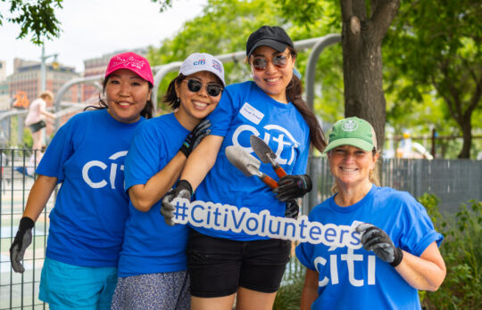 Volunteers pose with sign at Citi Family Day 2026 in Hudson River Park