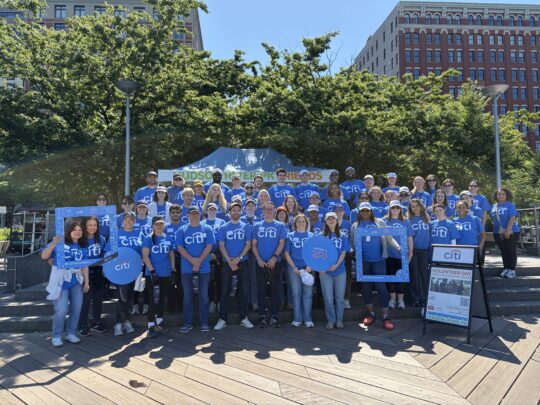 Citi volunteers posed in front of Hudson River Park tent