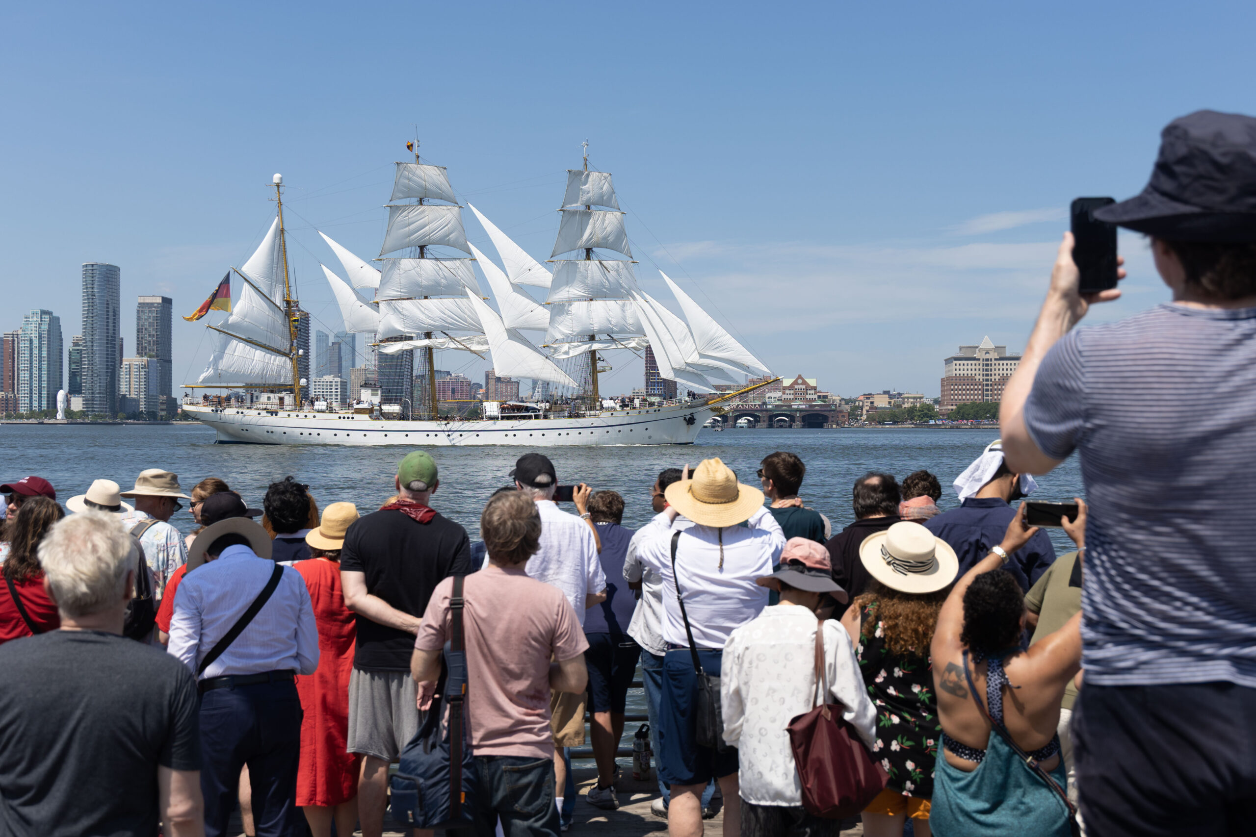 Crowds gather at tall ship sailing along Hudson River waterfront