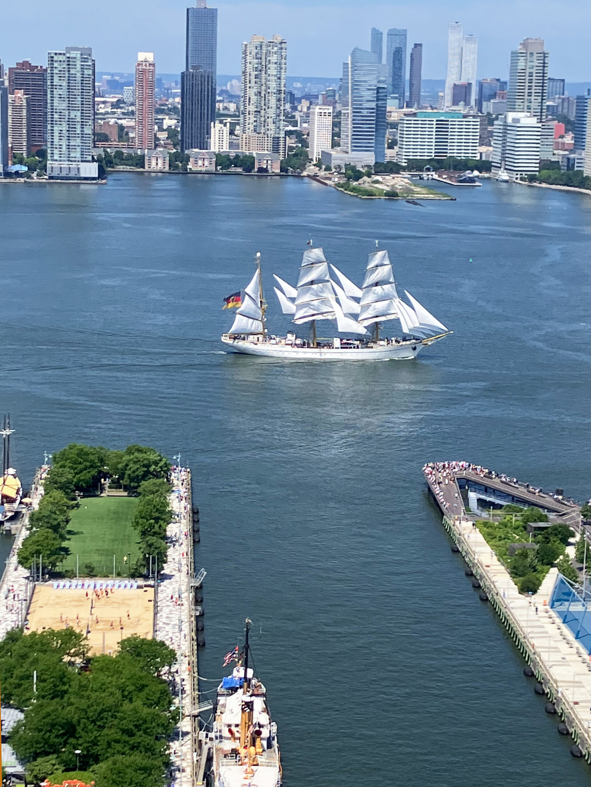 Tall ship sails past Pier 25 and Pier 26 in Hudson River Park, photographed from above